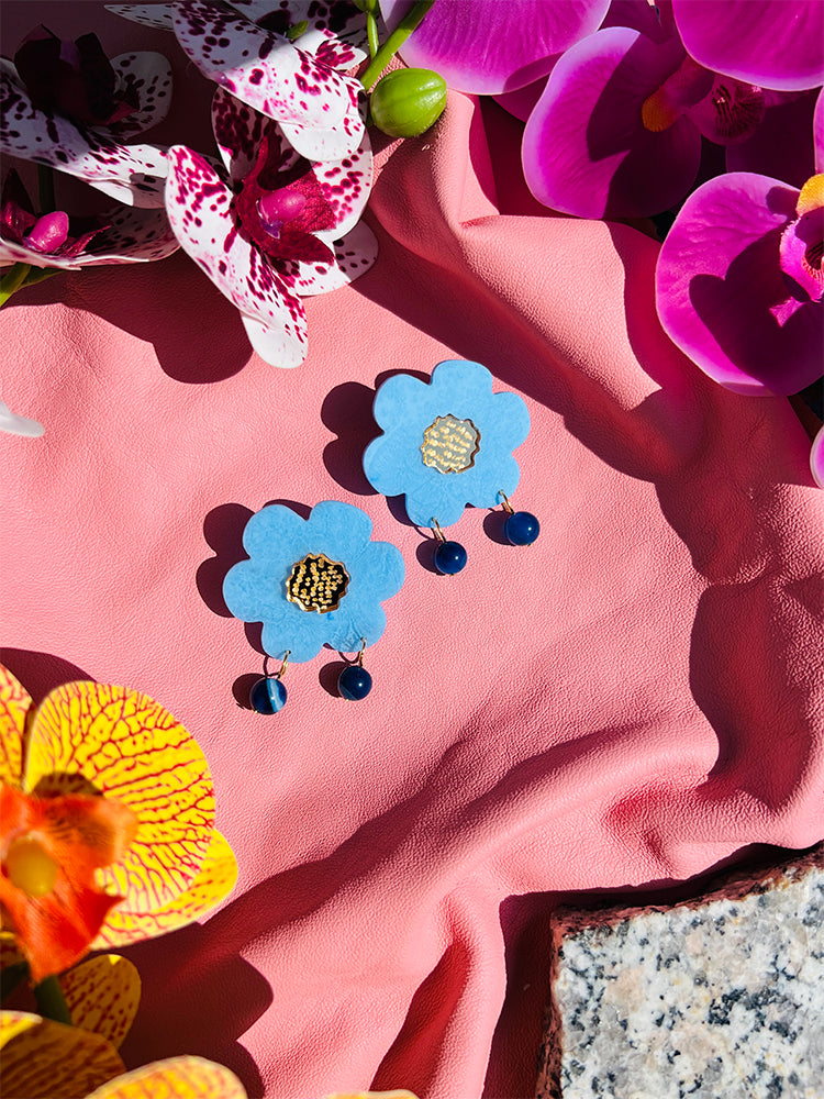 Fragole Fiore | Australian Sky Blue – Earrings catching the sunlight, reflecting their sky blue hue with a beautiful, radiant glow - styled shot