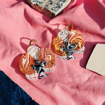 The Swirling Orchid | Acetate – Italian handmade earrings crafted from premium acetate, featuring delicate floating orchid blooms in a soft, elegant design - styled shot