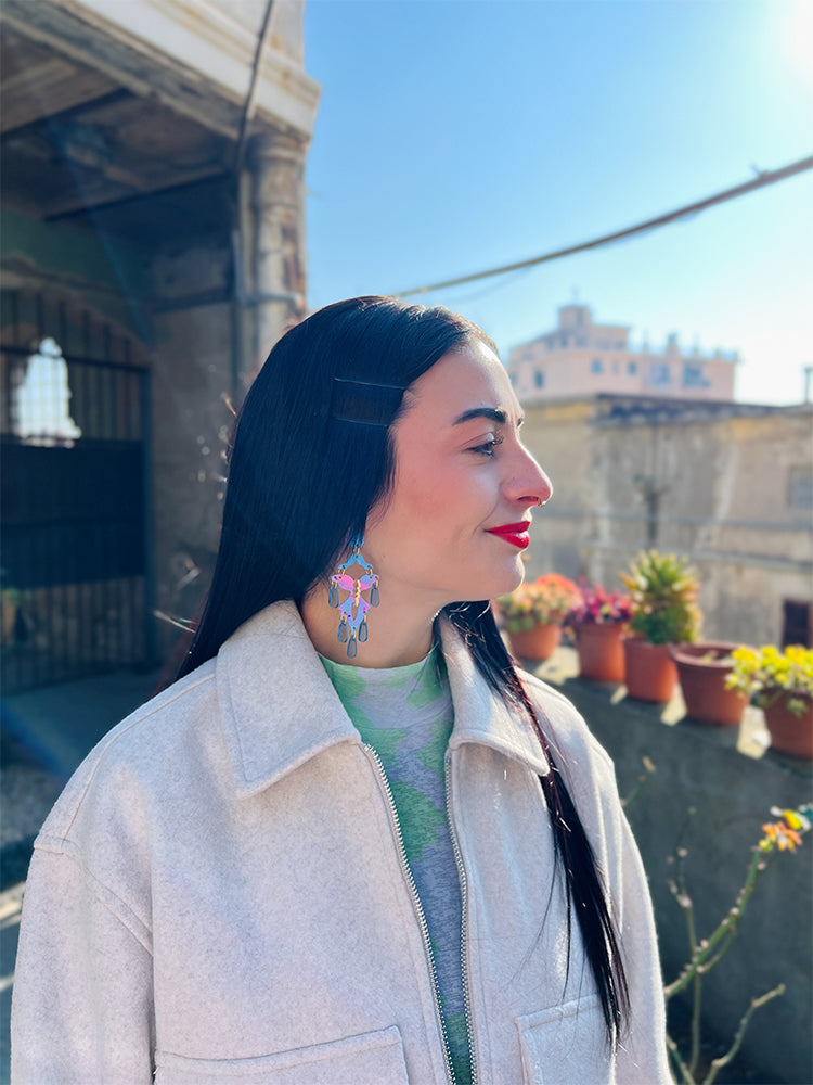 Style shot of the earrings worn – colourful butterfly charms bringing fun vibes to any outfit, model.