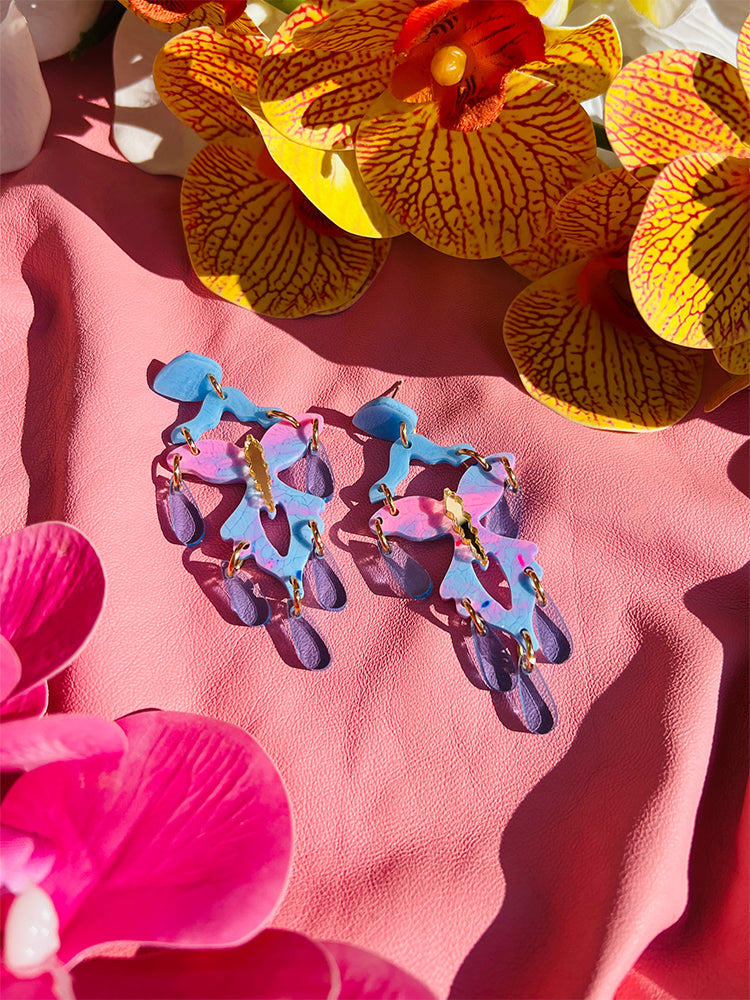 The butterfly, style shot showing the earrings as part of a wedding guest outfit
